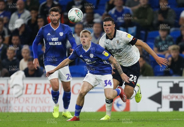 270819 - Cardiff City v Luton Town, EFL  Cup, Round 2 - James Waite of Cardiff City looks to win the ball as Lloyd Jones of Luton Town challenges