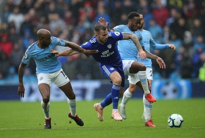 220918 - Cardiff City v Manchester City, Premier League - Joe Ralls of Cardiff City and Raheem Sterling of Manchester City compete for the ball