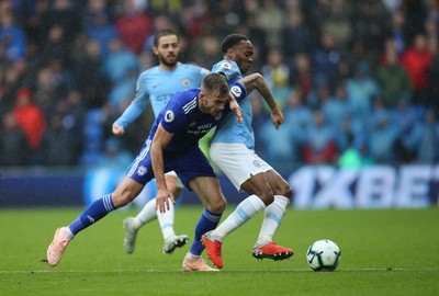 220918 - Cardiff City v Manchester City, Premier League - Joe Ralls of Cardiff City and Raheem Sterling of Manchester City compete for the ball