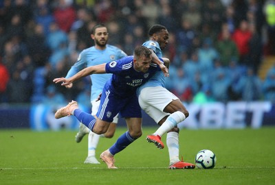 220918 - Cardiff City v Manchester City, Premier League - Joe Ralls of Cardiff City and Raheem Sterling of Manchester City compete for the ball