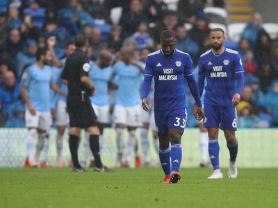 220918 - Cardiff City v Manchester City, Premier League - Junior Hoilett of Cardiff City and Jazz Richards of Cardiff City show the disappointment as Manchester City celebrate the fourth goal