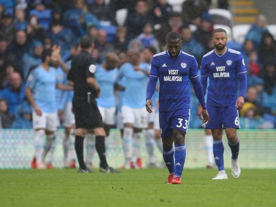 220918 - Cardiff City v Manchester City, Premier League - Junior Hoilett of Cardiff City and Jazz Richards of Cardiff City show the disappointment as Manchester City celebrate the fourth goal