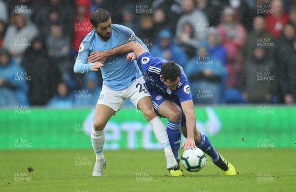 220918 - Cardiff City v Manchester City, Premier League - Bernardo Silva of Manchester City and Greg Cunningham of Cardiff City compete for the ball