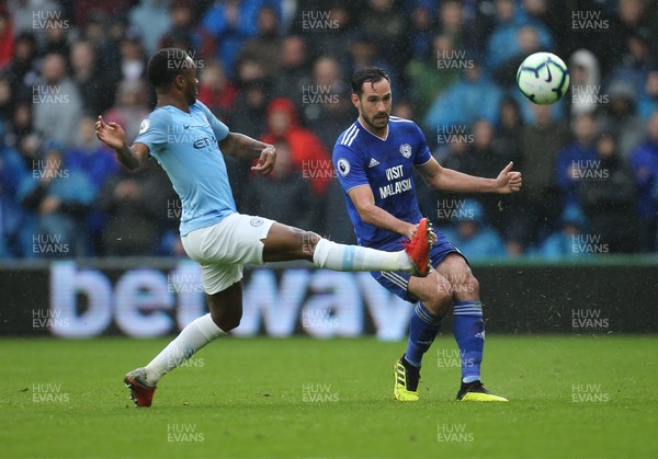 220918 - Cardiff City v Manchester City, Premier League - Raheem Sterling of Manchester City and Greg Cunningham of Cardiff City compete for the ball