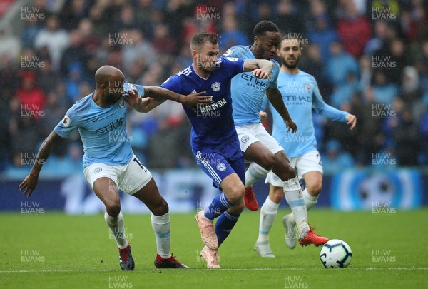 220918 - Cardiff City v Manchester City, Premier League - Joe Ralls of Cardiff City and Raheem Sterling of Manchester City compete for the ball