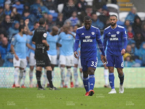220918 - Cardiff City v Manchester City, Premier League - Junior Hoilett of Cardiff City and Jazz Richards of Cardiff City show the disappointment as Manchester City celebrate the fourth goal