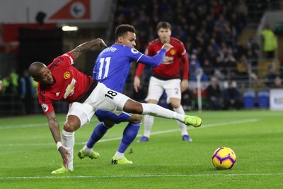 221218 - Cardiff City v Manchester United, Premier League - Ashley Young of Manchester United and Josh Murphy of Cardiff City compete for the ball