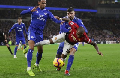 221218 - Cardiff City v Manchester United, Premier League - Ashley Young of Manchester United is challenged for the ball by Josh Murphy of Cardiff City and Callum Paterson of Cardiff City