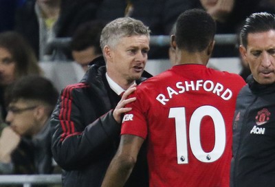 221218 - Cardiff City v Manchester United, Premier League - Manchester United manager Ole Gunnar Solskjaer speaks to Marcus Rashford of Manchester United as he is substituted