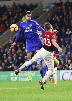 221218 - Cardiff City v Manchester United, Premier League - Josh Murphy of Cardiff City and Luke Shaw of Manchester United compete for the ball