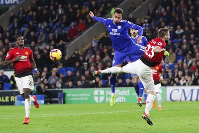 221218 - Cardiff City v Manchester United, Premier League - Josh Murphy of Cardiff City and Luke Shaw of Manchester United compete for the ball