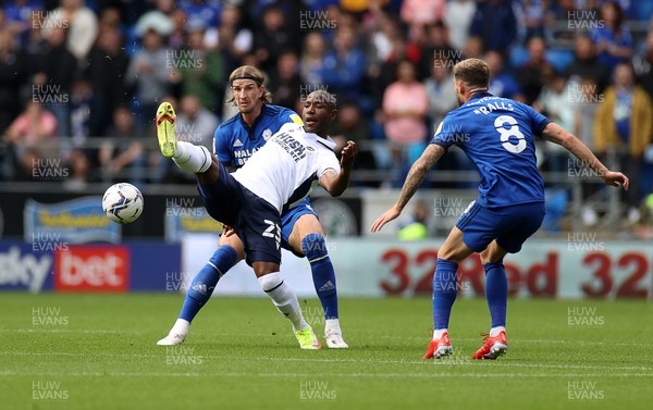 210821 - Cardiff City v Millwall - SkyBet Championship - Benik Afobe of Millwall is challenged by Aden Flint of Cardiff City