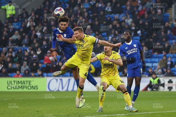 210123 - Cardiff City v Millwall, EFL Sky Bet Championship - Kion Etete of Cardiff City looks to head at goal as Shaun Hutchinson of Millwall challenges