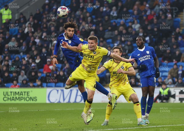 210123 - Cardiff City v Millwall, EFL Sky Bet Championship - Kion Etete of Cardiff City looks to head at goal as Shaun Hutchinson of Millwall challenges