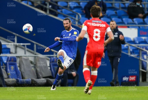 300121 - Cardiff City v Millwall, Sky Bet Championship - Sean Morrison of Cardiff City plays the ball forward past Ben Thompson of Millwall