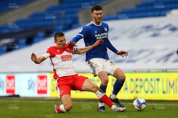 300121 - Cardiff City v Millwall, Sky Bet Championship - Kieffer Moore of Cardiff City is tackled by Shaun Hutchinson of Millwall