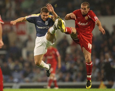 26.08.08...Cardiff City v MK Dons, Carling Cup Round 2 -  Cardiff's Stephen McPhail and M K Dons Paul Mitchell go for the ball 