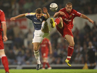 26.08.08...Cardiff City v MK Dons, Carling Cup Round 2 -  Cardiff's Stephen McPhail and M K Dons Paul Mitchell go for the ball 