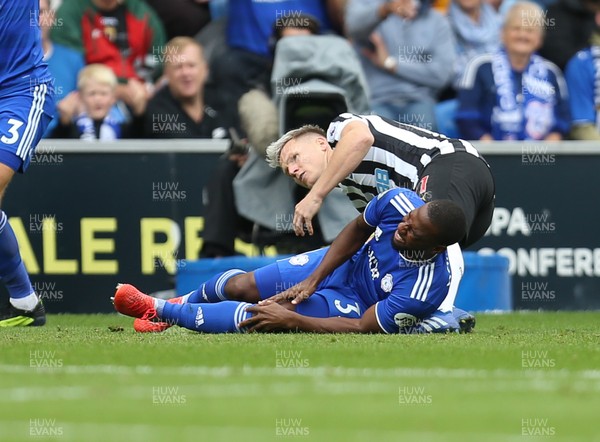 180818 - Cardiff City v Newcastle United, Premier League - Junior Hoilett of Cardiff City goes down in pain after being challenged