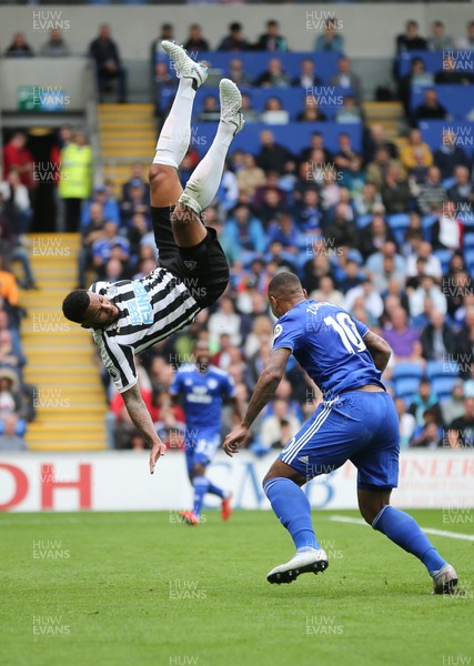 180818 - Cardiff City v Newcastle United, Premier League - Jamaal Lascelles of Newcastle United flies over the top of Kenneth Zohore of Cardiff City as he looks to win the ball