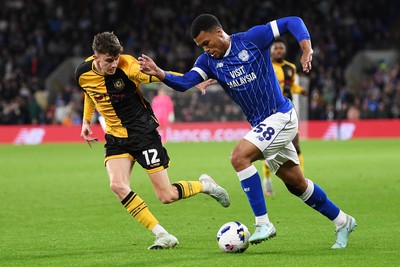 071025 - Cardiff City v Newport County - Vertu Trophy Group Stage - Joe Thomas of Newport County is challenged by T-Jay Parfitt of Cardiff City