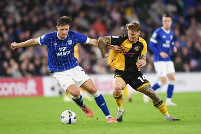 071025 - Cardiff City v Newport County - Vertu Trophy Group Stage - Kai Whitmore of Newport County is challenged by Will Fish of Cardiff City