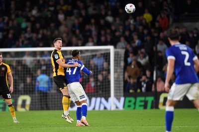 071025 - Cardiff City v Newport County - Vertu Trophy Group Stage - Ciaran Brennan of Newport County is challenged by Callum Robinson of Cardiff City
