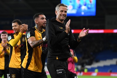 071025 - Cardiff City v Newport County - Vertu Trophy Group Stage - Newport County Manager, David Hughes is encouraged to celebrate to the fans by Courtney Baker-Richardson of Newport County