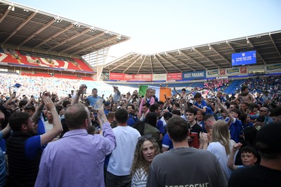 250426 - Cardiff City v Northampton Town - Sky Bet League 1 - Fans run onto the pitch at full time in celebration 