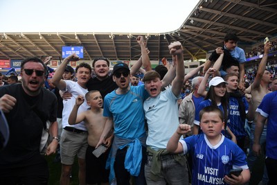 250426 - Cardiff City v Northampton Town - Sky Bet League 1 - Fans run onto the pitch at full time in celebration 