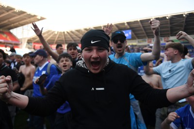 250426 - Cardiff City v Northampton Town - Sky Bet League 1 - Fans run onto the pitch at full time in celebration 