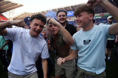 250426 - Cardiff City v Northampton Town - Sky Bet League 1 - Fans run onto the pitch at full time in celebration 