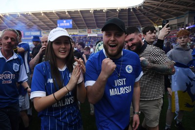 250426 - Cardiff City v Northampton Town - Sky Bet League 1 - Fans run onto the pitch at full time in celebration 