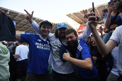 250426 - Cardiff City v Northampton Town - Sky Bet League 1 - Fans run onto the pitch at full time in celebration 