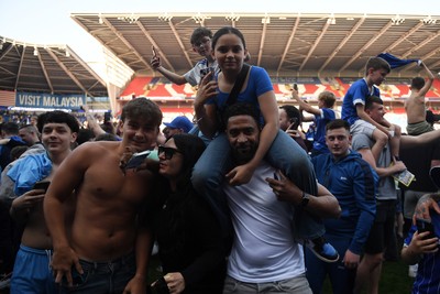 250426 - Cardiff City v Northampton Town - Sky Bet League 1 - Fans run onto the pitch at full time in celebration 