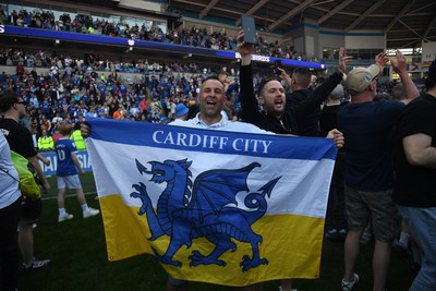 250426 - Cardiff City v Northampton Town - Sky Bet League 1 - Fans run onto the pitch at full time in celebration 