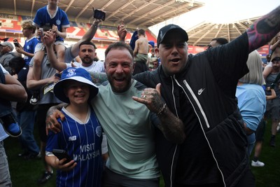250426 - Cardiff City v Northampton Town - Sky Bet League 1 - Fans run onto the pitch at full time in celebration 