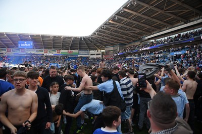 250426 - Cardiff City v Northampton Town - Sky Bet League 1 - Fans run onto the pitch at full time in celebration 