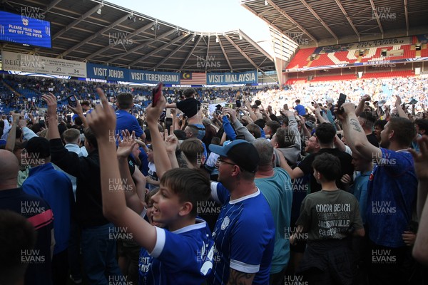 250426 - Cardiff City v Northampton Town - Sky Bet League 1 - Fans run onto the pitch at full time in celebration 