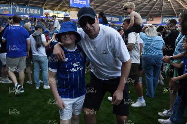 250426 - Cardiff City v Northampton Town - Sky Bet League 1 - Fans run onto the pitch at full time in celebration 
