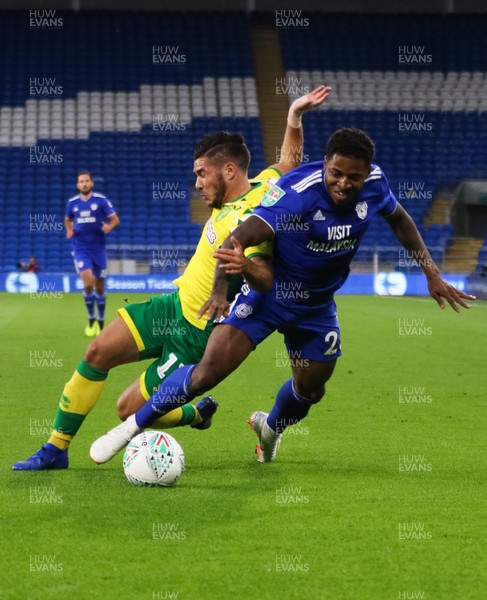 280818 - Cardiff City v Norwich City, Carabao Cup - Kadeem Harris of Cardiff City and Emiliano Buendia of Norwich City compete for the ball