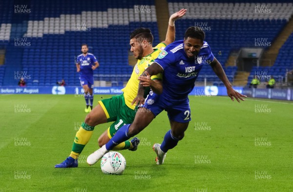 280818 - Cardiff City v Norwich City, Carabao Cup - Kadeem Harris of Cardiff City and Emiliano Buendia of Norwich City compete for the ball