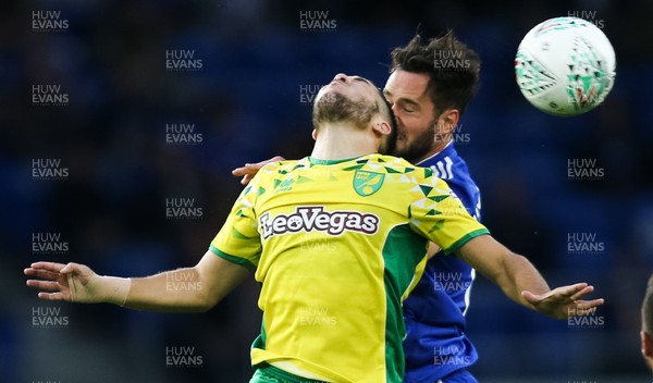280818 - Cardiff City v Norwich City, Carabao Cup - Emiliano Buendia of Norwich City and Greg Cunningham of Cardiff City compete for the ball