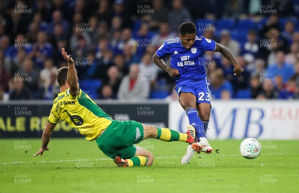 280818 - Cardiff City v Norwich City, Carabao Cup - Kadeem Harris of Cardiff City is tackled by Christoph Zimmermann of Norwich City as he shoots at goal