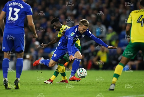 280818 - Cardiff City v Norwich City, Carabao Cup - Danny Ward of Cardiff City is tackled by Emiliano Buendia of Norwich City