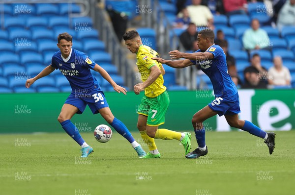 300722 - Cardiff City v Norwich City, Sky Bet Championship - Milot Rashica of Norwich City is tackled by Andy Rinomhota of Cardiff City