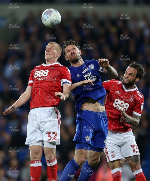 210418 - Cardiff City v Nottingham Forest - SkyBet Championship - Sean Morrison of Cardiff City goes up for the ball with Ben Watson and Danny Fox of Nottingham Forest