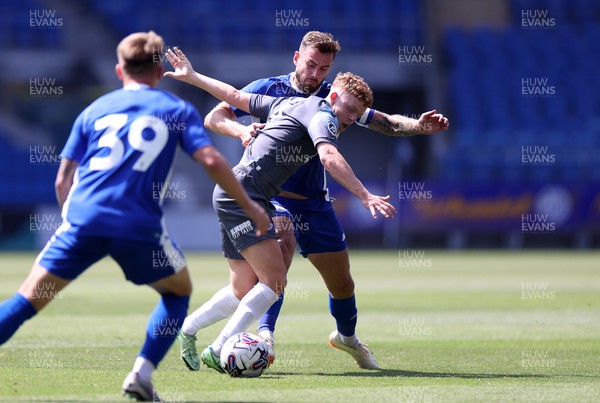 010723 - Cardiff City v Penybont FC - Pre Season Friendly - Lewis Clutton of Penybont FC is challenged by Joe Ralls of Cardiff City 