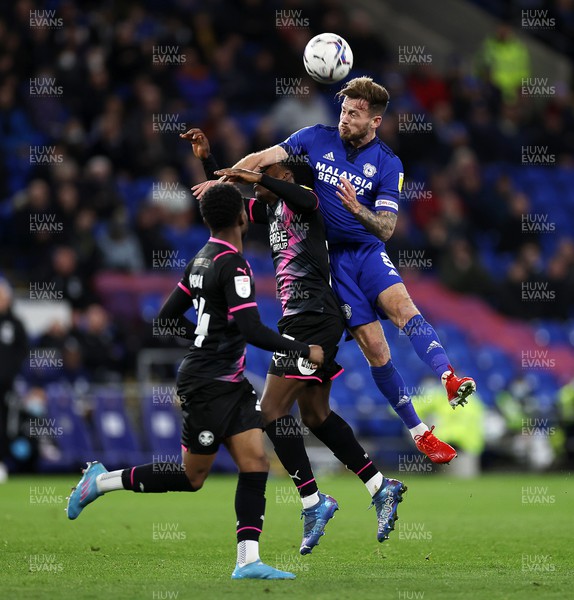 090222 - Cardiff City v Peterborough United - SkyBet Championship - Joe Ralls of Cardiff City goes up for the ball with Kwame Poku of Peterborough United