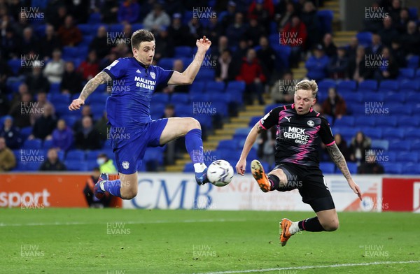 090222 - Cardiff City v Peterborough United - SkyBet Championship - Jordan Hugill of Cardiff City gets the ball past Frankie Kent of Peterborough United to score their third goal of the game